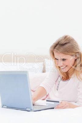 Close up, Woman using laptop on the bed while looking at the scr