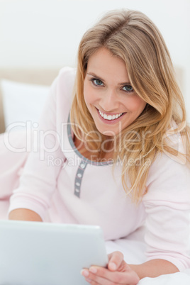 Woman holding tablet pc and smiling