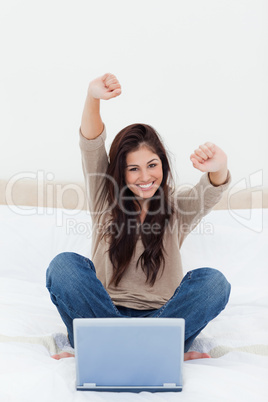 Woman looks straight ahead as she celebrates in front of her lap