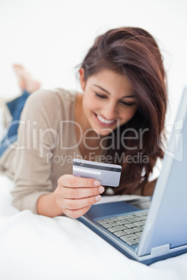 Focus shot, woman looking at her credit card in front of her lap