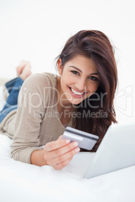 Close up, woman smiling with credit card and tablet in hand, lyi