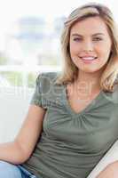 Focus shot, woman smiling on the couch and relaxing