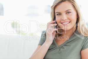 Woman smiling as she makes a phonecall