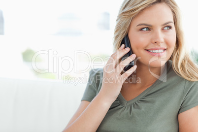 Woman smiling as she makes a call and looks to the side