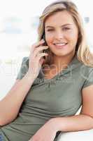 Close up, woman making a call, smiling and looking straight ahea