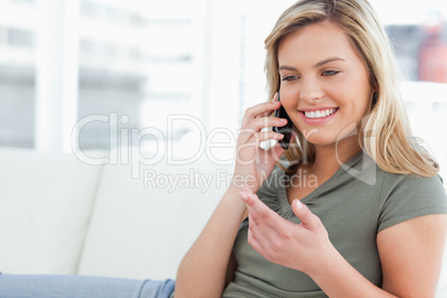 Woman with raised hand, making a call and smiling