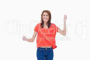 Teenager giggling with arms raised