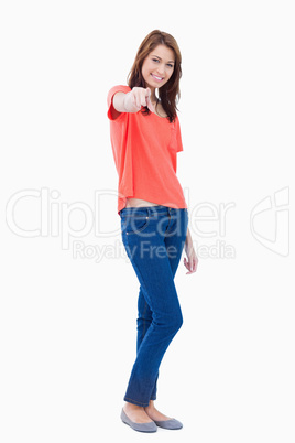 Teenager tilting her head while pointing her finger