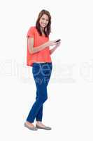 Side view of a teenage girl sending a text