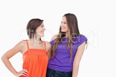 Smiling teenagers friendly looking at each other