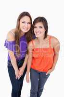 Two teenage girls leaning forward