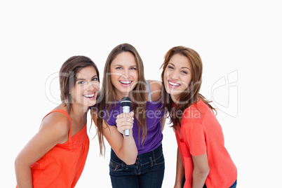 Teenagers smiling while singing a karaoke