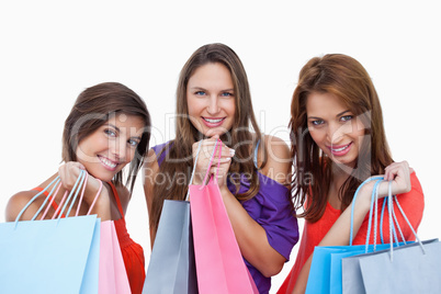 Teenage girls proudly coming back from shopping