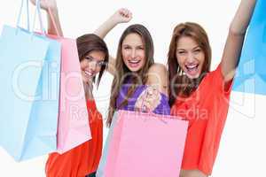 Young women elevating their purchase bags
