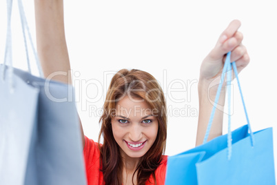 Smiling teenage girl holding shopping bags