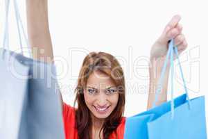 Smiling teenage girl holding shopping bags