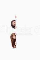 Two teenage girls getting their heads out of a blank poster
