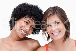 Teenage girls smiling and posing against a white background
