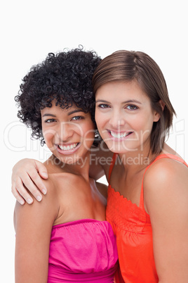 Teenagers smiling while putting their hands on each others shoul