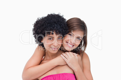 Happy teenage girls hugging each other