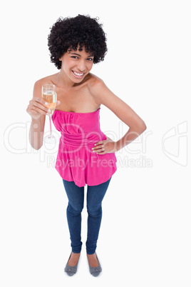 Young woman leaning her body forward while drinking white wine