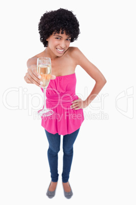 Young woman smiling while holding a glass of white wine