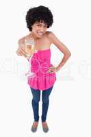 Young woman smiling while holding a glass of white wine