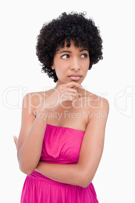 Thoughtful teenage girl putting her hand on her chin while looki