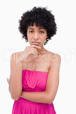 Serious young woman placing her hand on her chin