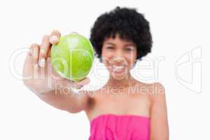 Green apple held by a young woman