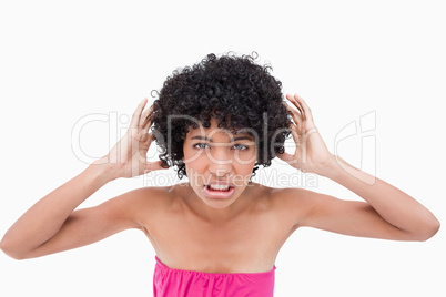 Young woman placing her hands beside her ears
