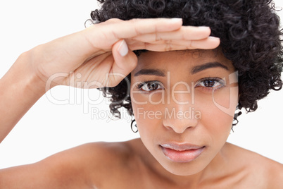 Young female placing her hand above her eyes for a better better