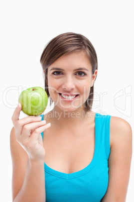 Young woman holding a green apple in her right hand