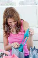 Young woman looking at her new blue swimsuit