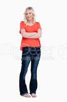 Smiling teenager crossing her arms while standing upright