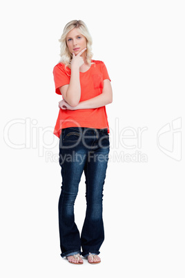 Serious teenager wearing casual clothes and standing with her fi