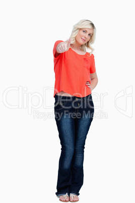 Teenage putting her thumbs up with a hand on her hip