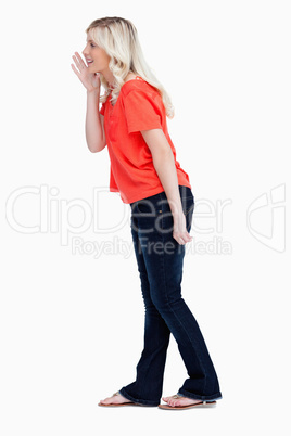 Side view of a teenager girl calling for someone