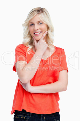 Smiling teenager crossing her arms while placing her fingers on