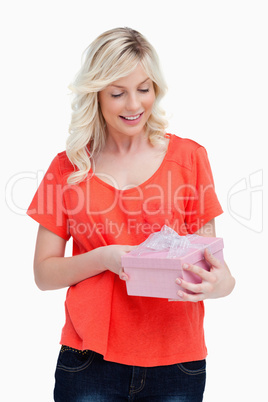 Surprised fair-haired teenager receiving a gift