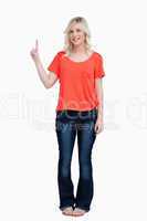 Smiling teenager raising her finger in the air