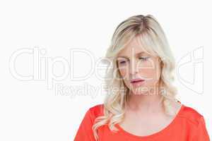 Sad woman standing upright while looking down