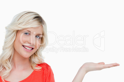 Smiling woman putting her hand palm up