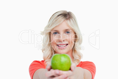 Smiling woman holding a delicious green apple