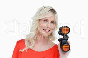 Beautiful woman holding a pair of binoculars