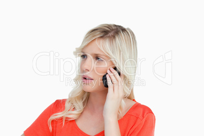 Serious woman talking on the phone while looking on the side