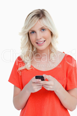 Woman beaming while sending a text with her cellphone