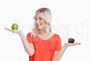 Woman imitating the food-balance to choose between an apple and