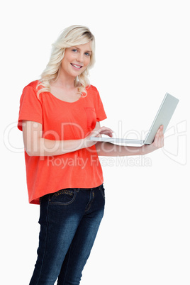 Smiling woman looking straight at the camera while holding a lap