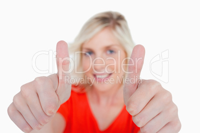 Thumbs up showed by a young blonde woman